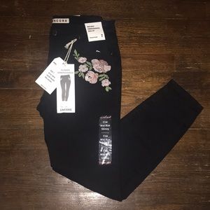 Flower embroidered mid rise skinny black jeans